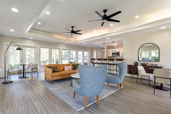 A living room with a blue chair in the foreground.